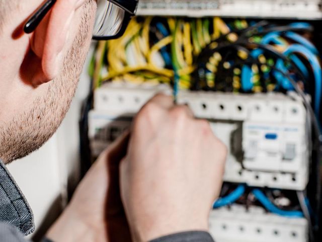 Electrician wiring a consumer unit